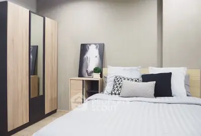 Modern bedroom with stylish decor and cozy bedding in a contemporary apartment.