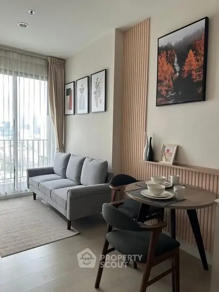 Modern living room with stylish decor and city view from large window.