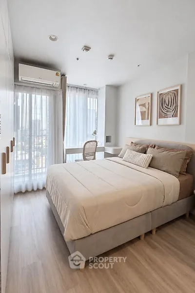 Modern bedroom with large window and stylish decor in urban apartment