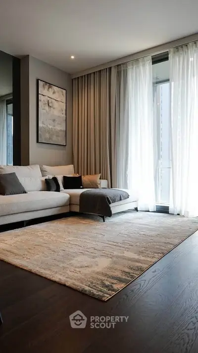 Elegant living room with modern decor and large window drapes, featuring a cozy sectional sofa and stylish rug.