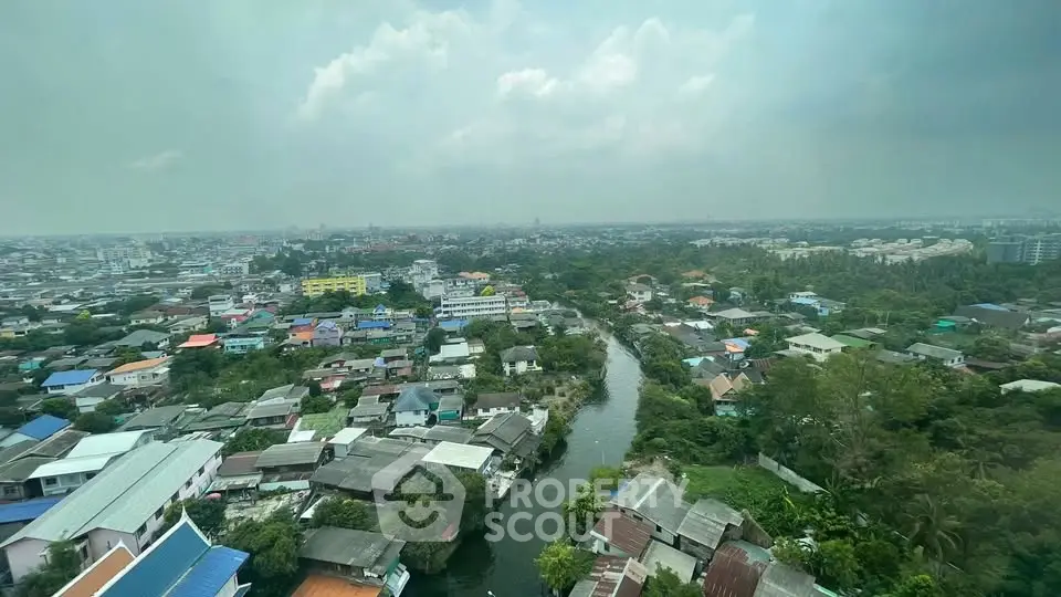 Stunning aerial view of a vibrant cityscape with lush greenery and a winding river, perfect for urban living.