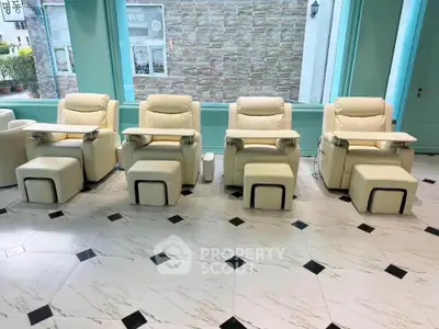 Luxurious spa chairs in a modern wellness center with elegant marble flooring.