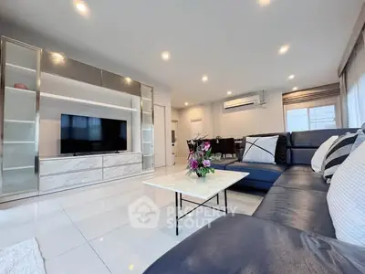 Spacious modern living room with sleek design and ample natural light, perfect for relaxation and entertainment.