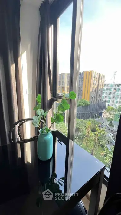 Modern apartment with large windows offering stunning city views and abundant natural light.