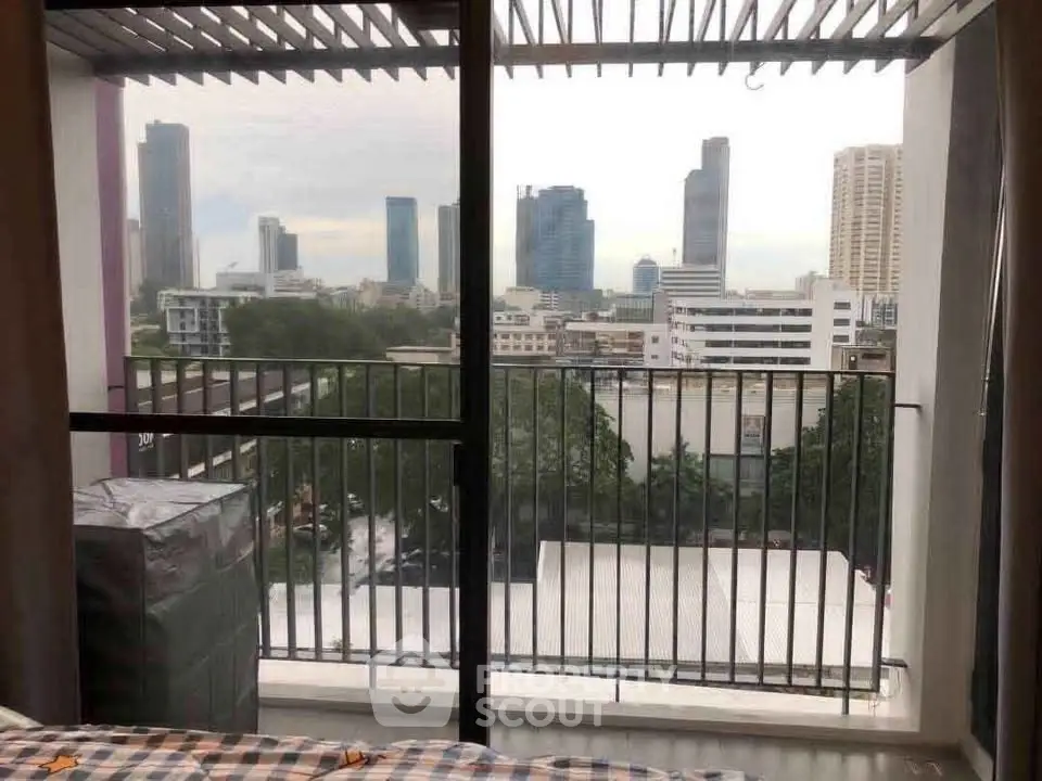 Stunning cityscape view from a modern apartment balcony, showcasing urban skyline and lush greenery.