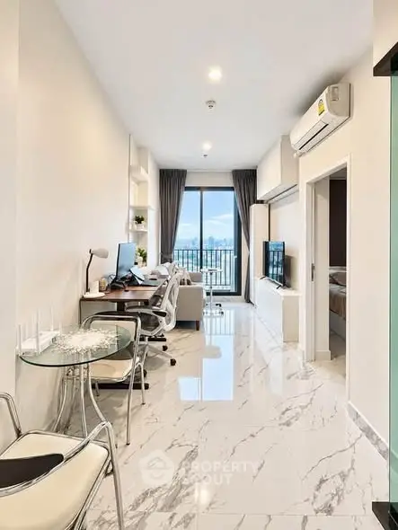 Modern living room with marble flooring, stylish furniture, and a stunning city view from the balcony.
