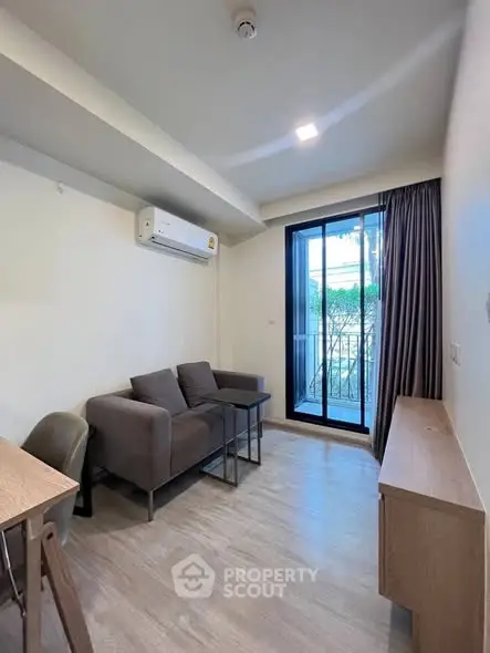 Modern living room with sleek furniture and balcony view in a stylish apartment.
