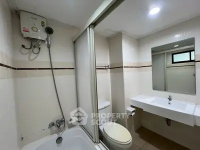 Modern bathroom with bathtub and shower in a sleek real estate property