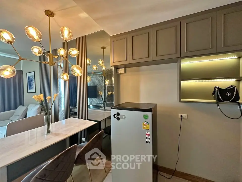 Modern kitchen with stylish lighting and sleek cabinetry in a contemporary apartment.