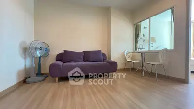 Modern living room with purple sofa and stylish decor