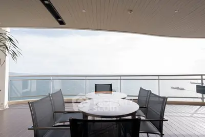 Luxurious balcony with stunning ocean view and modern outdoor furniture.