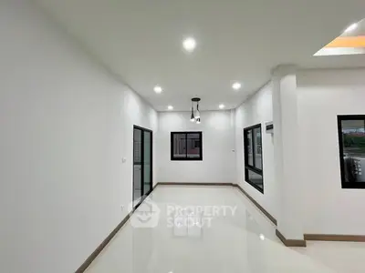 Spacious modern living room with sleek lighting and large windows