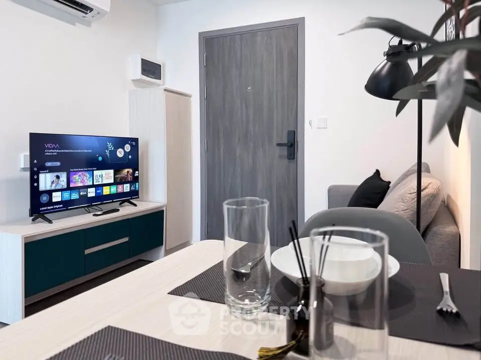 Modern living room with sleek furniture and smart TV, perfect for urban living.