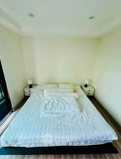 Spacious bedroom with minimalist decor and large bed, perfect for relaxation and comfort.