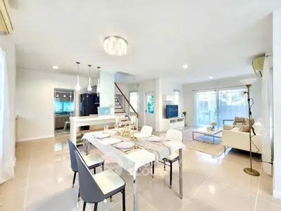 Spacious open-plan living and dining area with modern decor and natural light