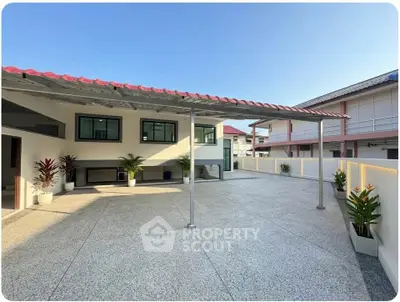 Spacious rooftop terrace with modern design and ample natural light, perfect for outdoor gatherings.