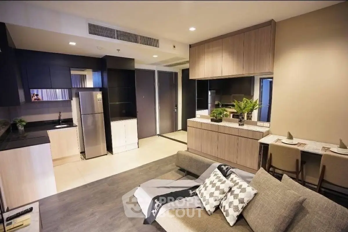Modern open-layout living room with sleek kitchen and stylish decor