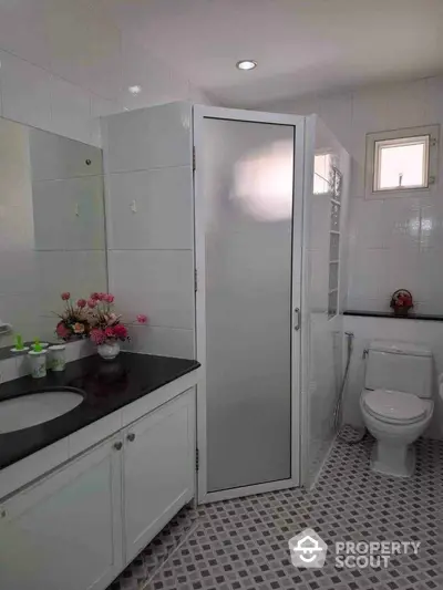 Modern bathroom with sleek design and frosted glass shower door