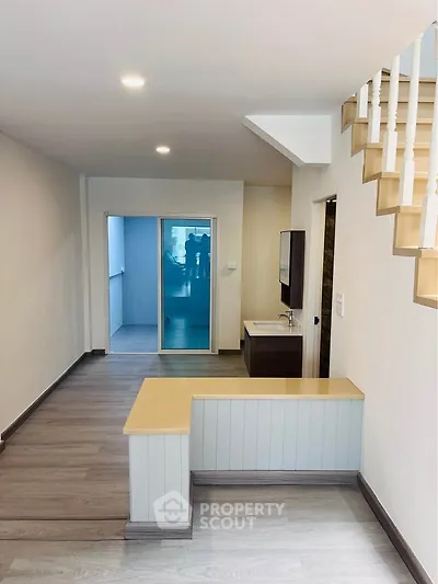 Modern interior with sleek staircase and open layout, perfect for stylish urban living.