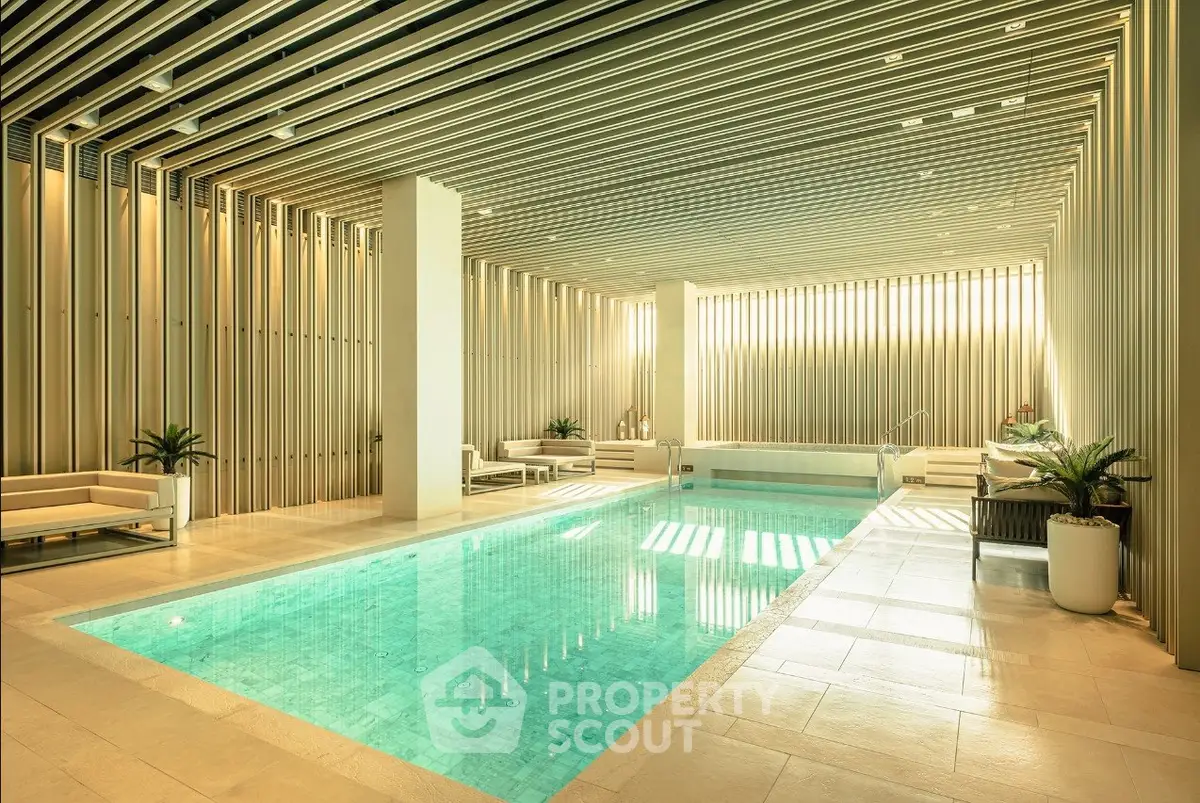 Luxurious indoor pool area with modern design and elegant seating.