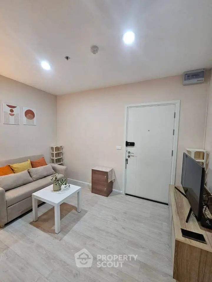 Modern living room with cozy sofa, stylish decor, and sleek TV setup in a contemporary apartment.