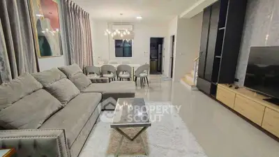 Spacious modern living room with elegant decor and dining area, perfect for family gatherings.