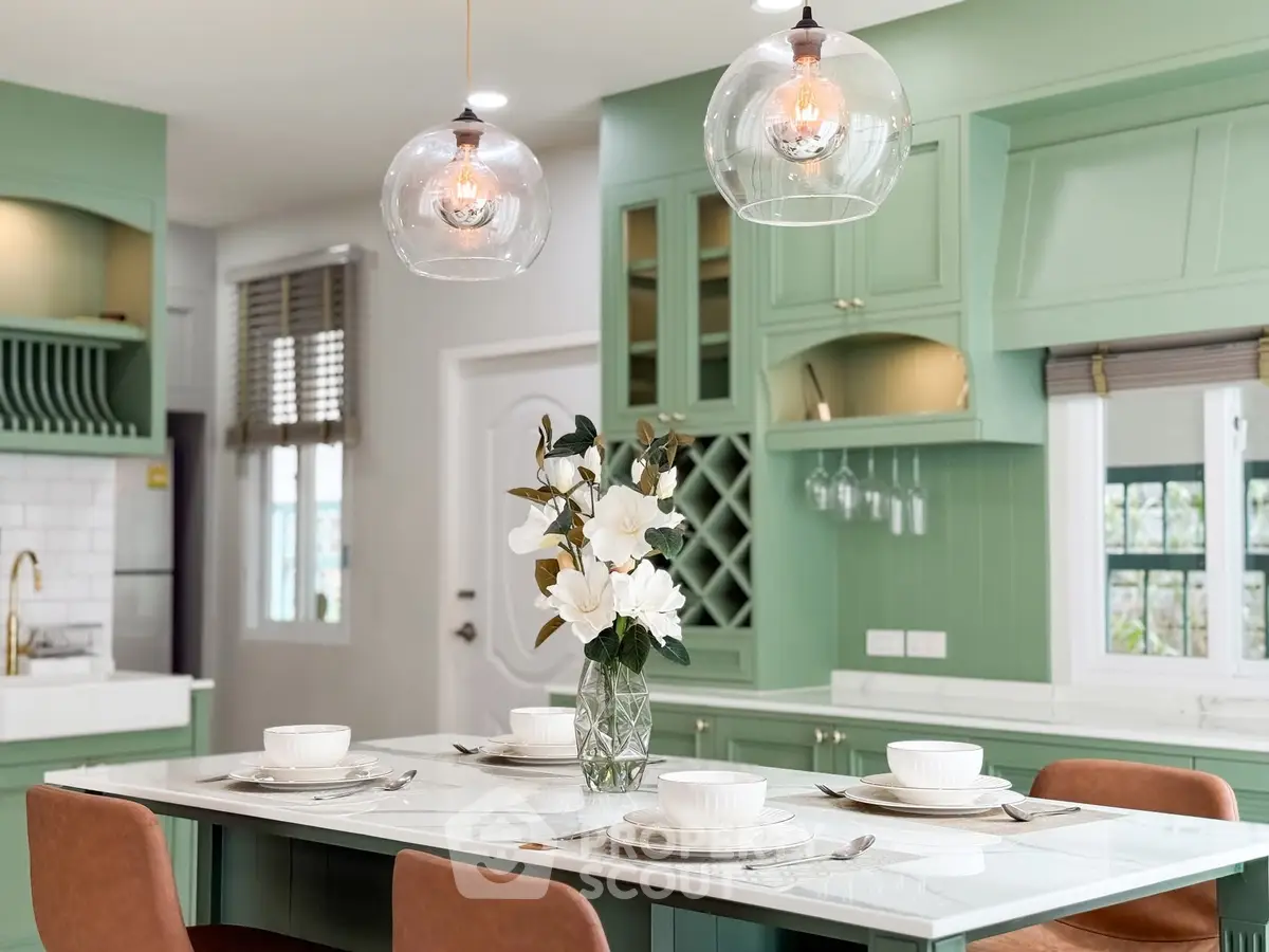 Elegant kitchen with mint green cabinets and modern lighting