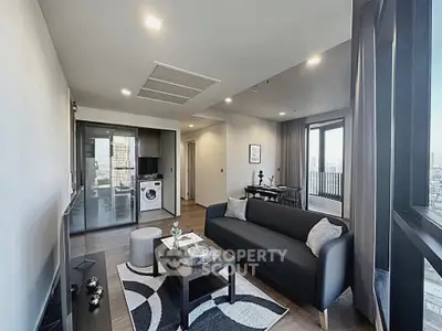 Modern living room with sleek furniture and city view balcony in a stylish apartment.
