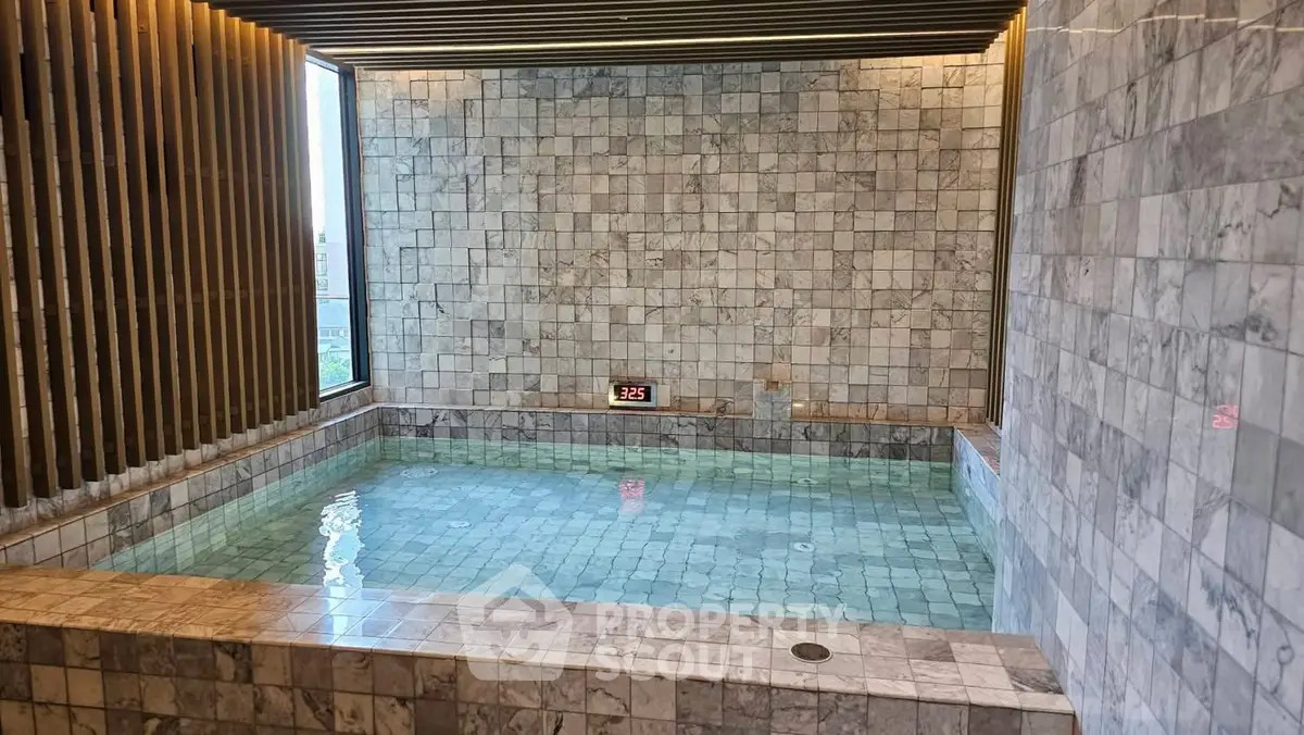 Luxurious indoor pool with marble tiles and modern design