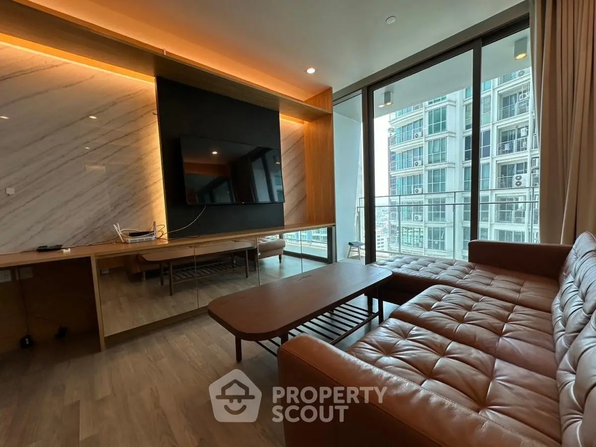 Luxurious living room with modern decor and stunning city view from balcony.