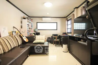 Cozy living room with modern furniture and entertainment setup, perfect for relaxation and leisure.