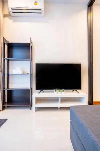 Modern living room with sleek TV setup and stylish shelving unit