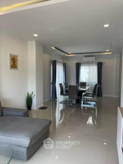 Spacious modern living room with elegant dining area and sleek furniture