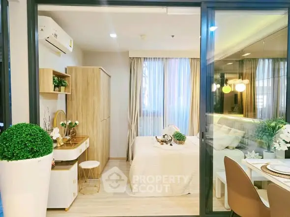 Modern bedroom with stylish decor and natural light, featuring a cozy bed and elegant furnishings.