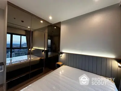 Modern bedroom with large mirrored wardrobe and city view window