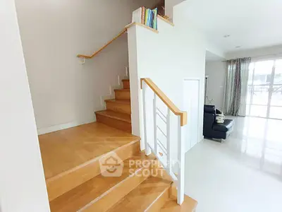 Modern interior with wooden staircase and bright living area