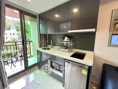 Modern kitchen with sleek cabinetry and balcony view in stylish apartment