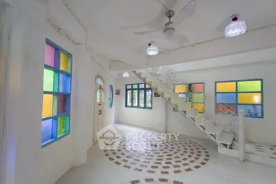 Charming interior with colorful stained glass windows and unique staircase design