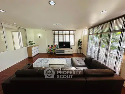 Spacious living room with modern decor and large windows for natural light.