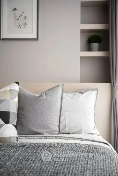 Cozy bedroom with stylish decor and soft lighting, perfect for relaxation.