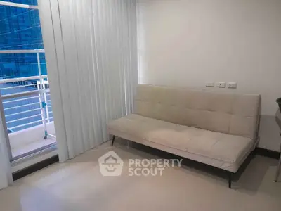 Modern apartment interior with sleek sofa and balcony view