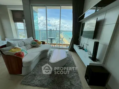 Luxurious living room with stunning ocean view and modern entertainment setup.