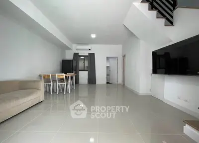 Spacious modern living room with sleek tile flooring and minimalist decor
