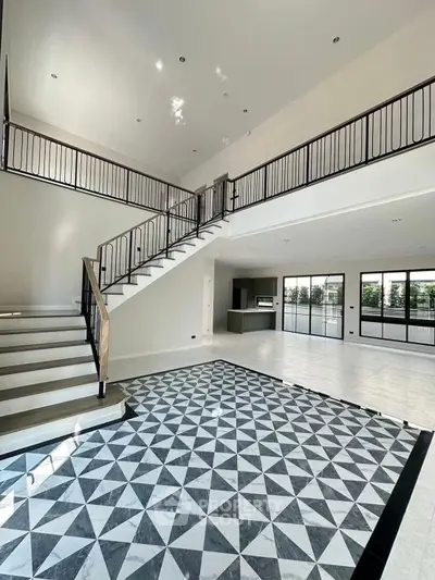 Spacious modern living room with high ceilings and elegant staircase