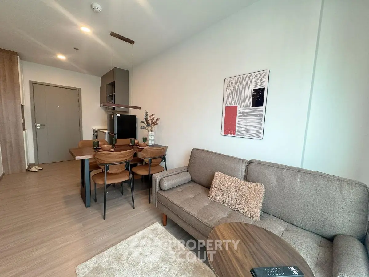 Modern living room with cozy sofa and dining area in stylish apartment