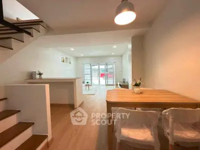 Spacious open-plan living and dining area with modern decor and natural light.
