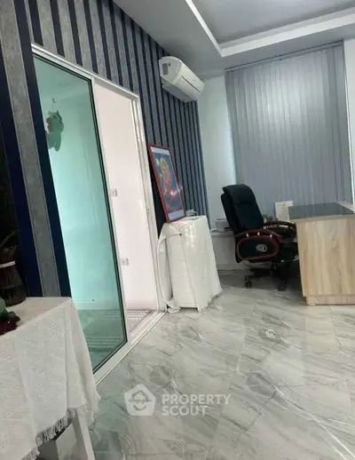 Modern office space with sleek design, featuring a glass door, air conditioning, and stylish furniture.