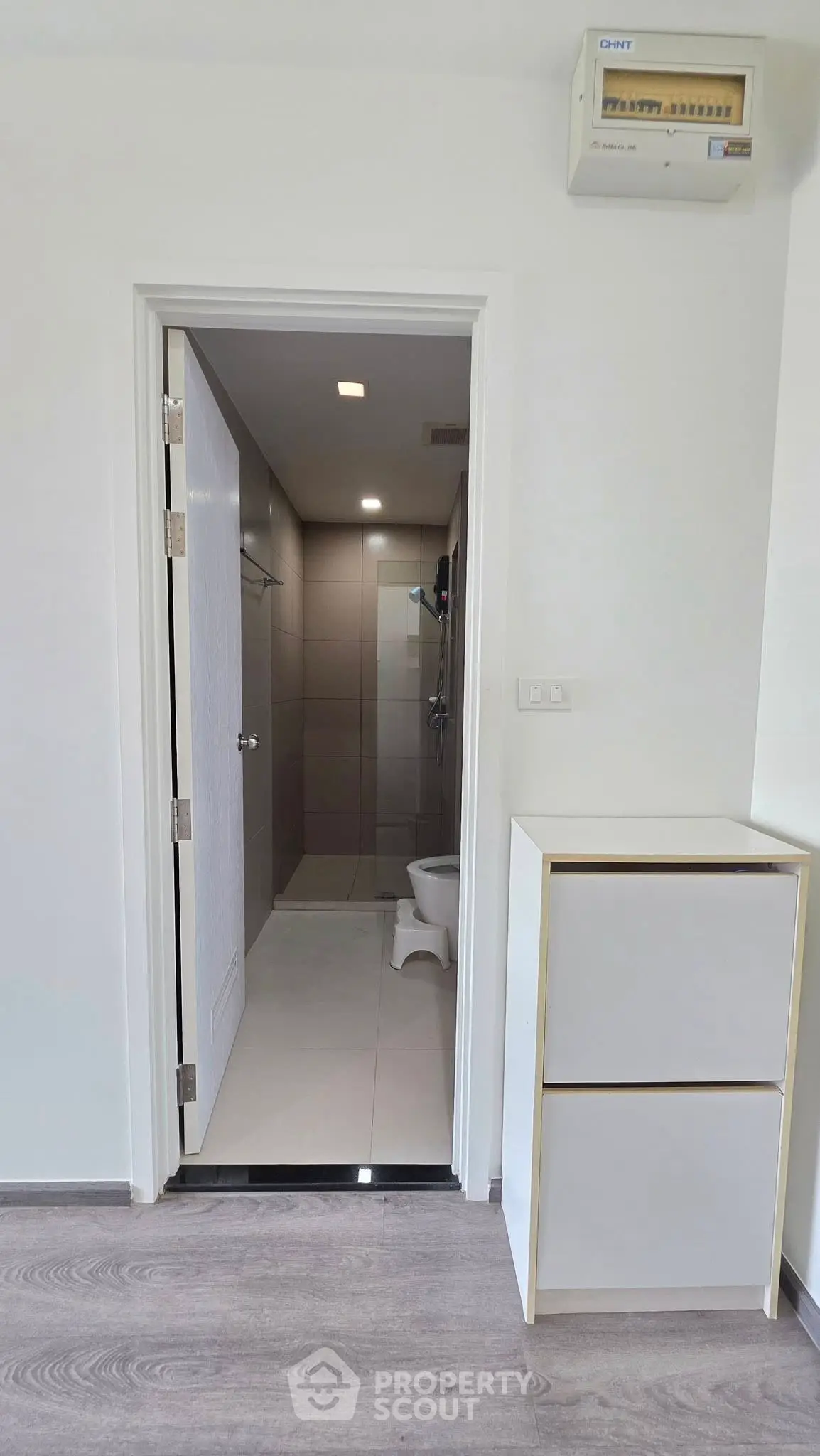 Modern bathroom entrance with sleek design and neutral tones