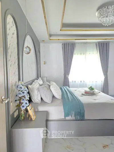 Elegant bedroom with modern decor, plush bedding, and stylish curtains