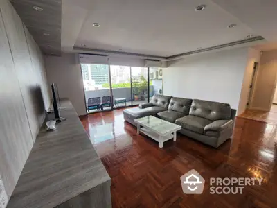 Spacious living room with modern furniture and city view balcony